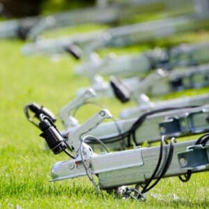 A row of bicycles parked in the grass.