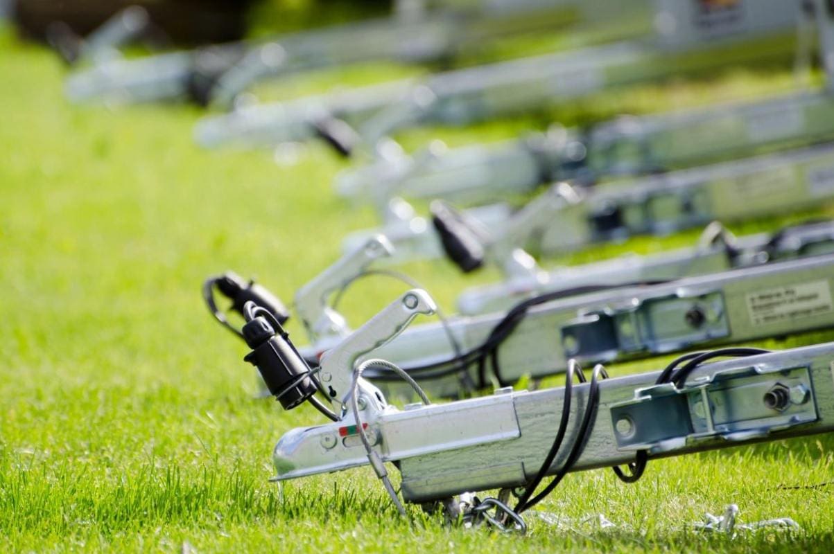 A row of bicycles parked in the grass.