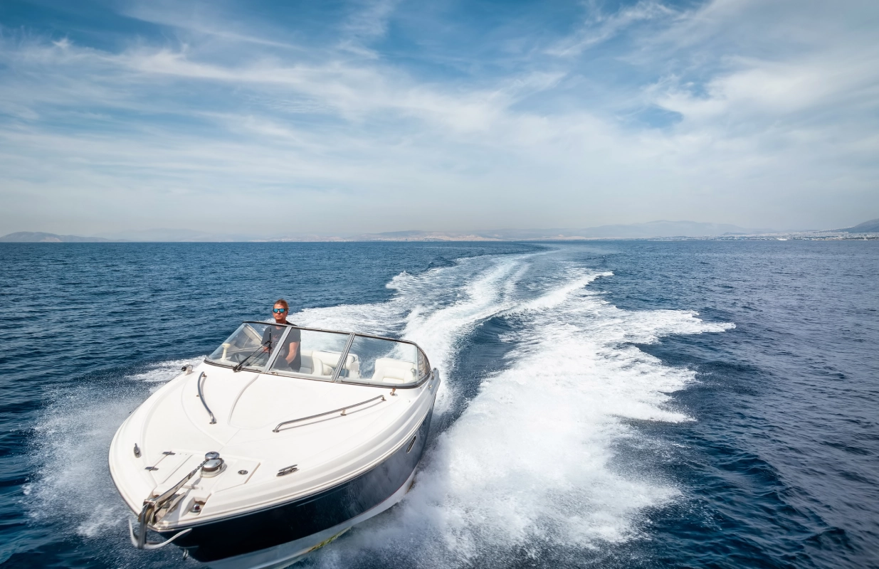 A man is in the boat on the water.