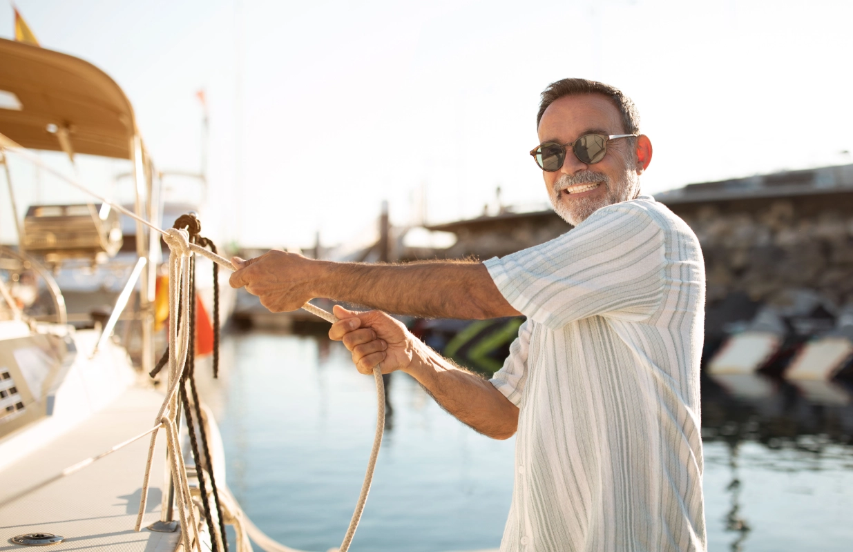 A man holding onto the rope of a boat