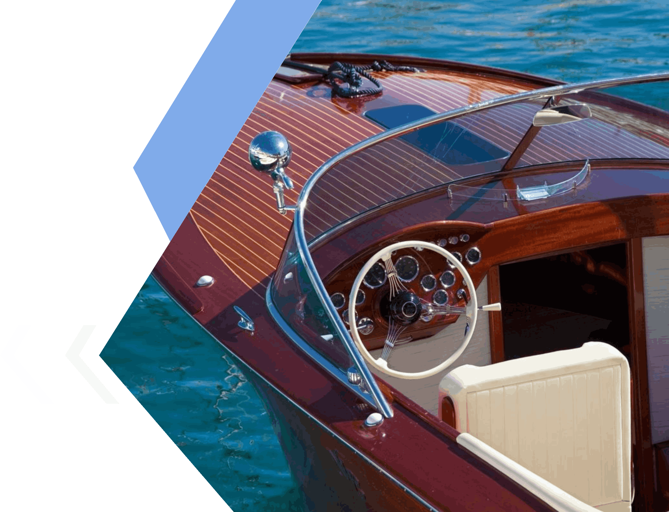A boat with the steering wheel and dashboard in front of water.